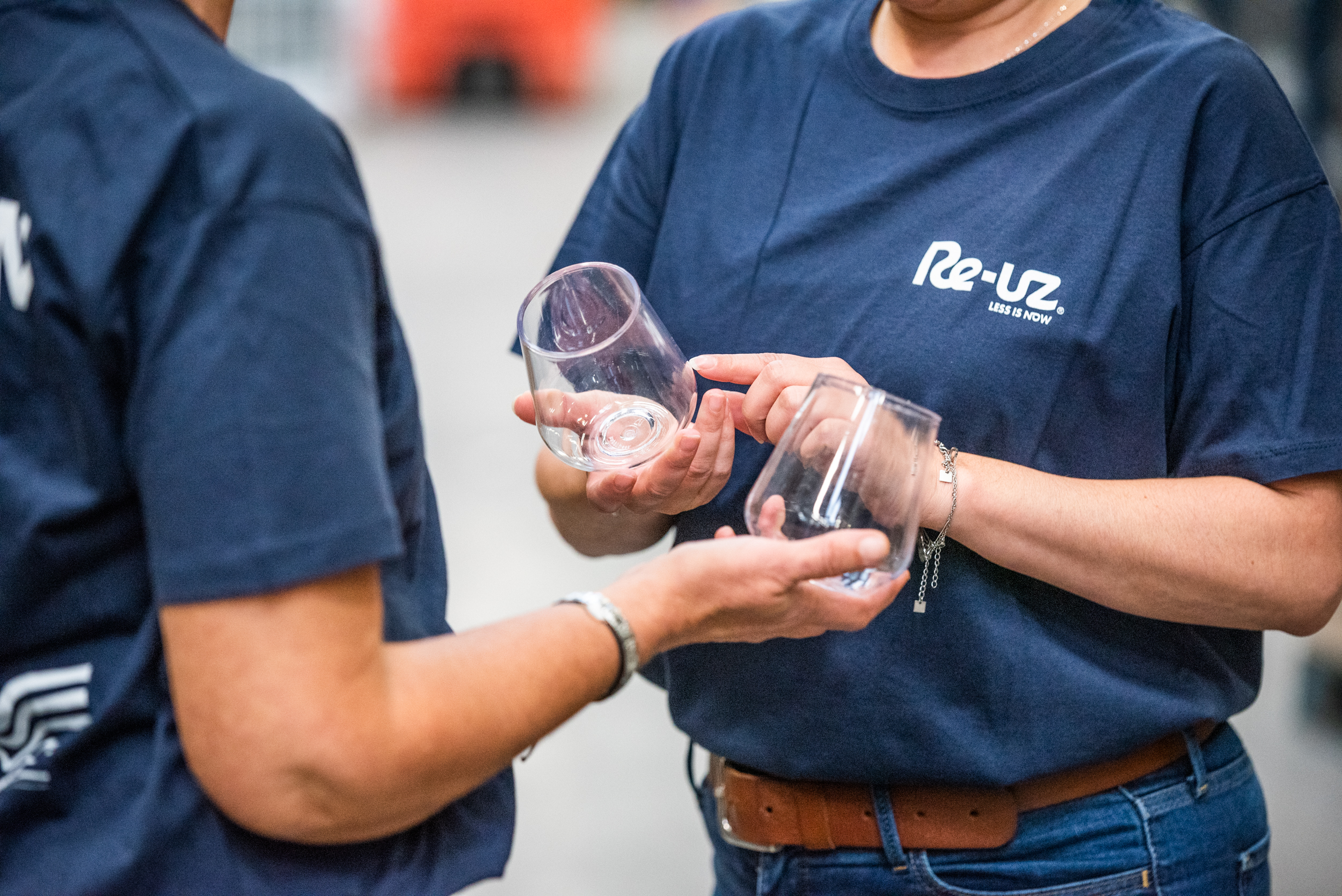 Two members of the Re-uz team reviewing the personalization of a shatterproof glass